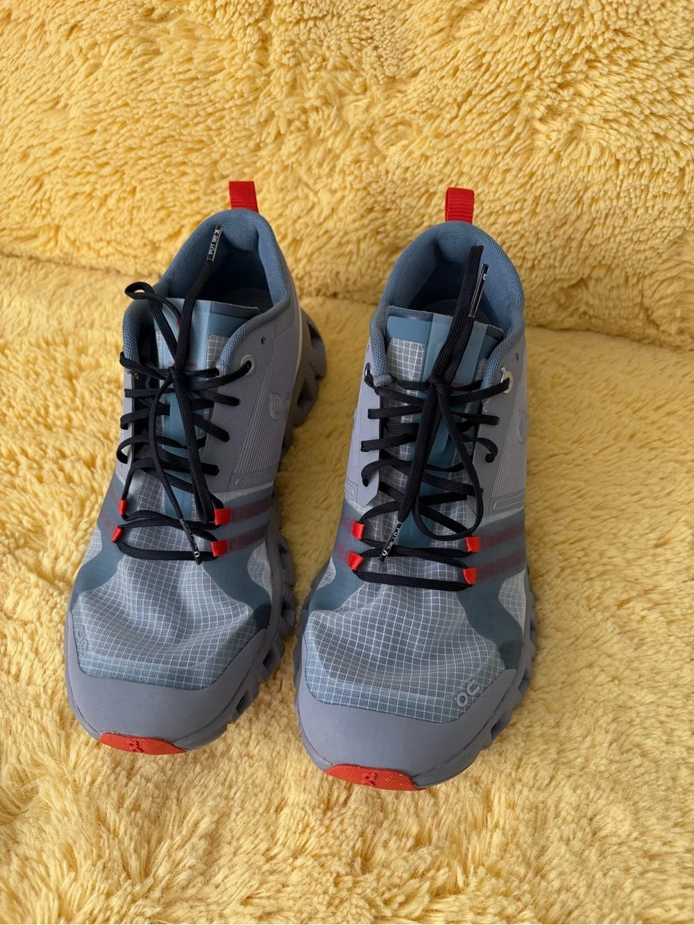 On Running Gray and Red Trail Runners